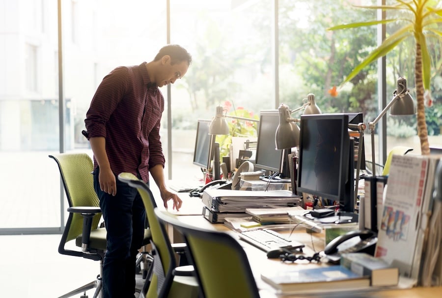 employer looks at empty desk