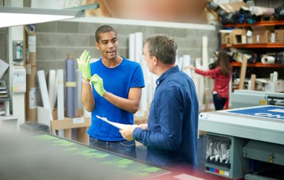 Image of a worker and boss in a print shop