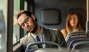 worker asleep on a bus