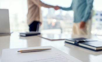People shaking hands over a contract