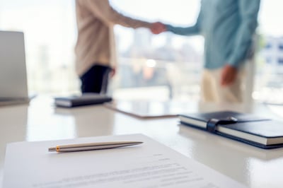 People shaking hands over a contract