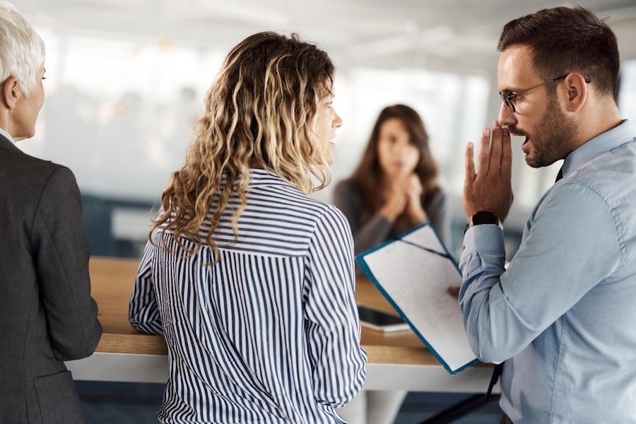 Managers gossiping about employee