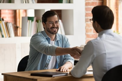 Employee shakes boss' hand