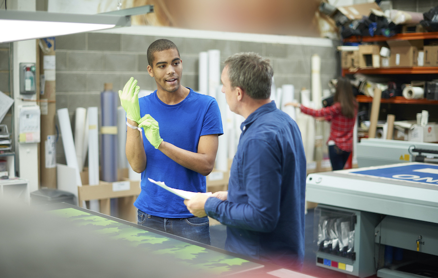 Image of a worker and boss in a print shop