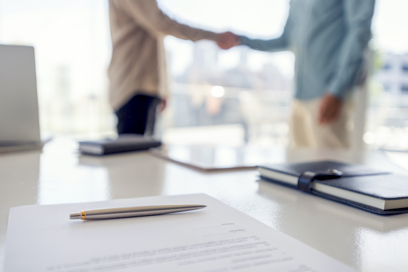 People shaking hands over a contract