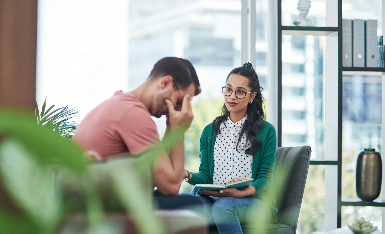 Image of a worker consoling a coworker