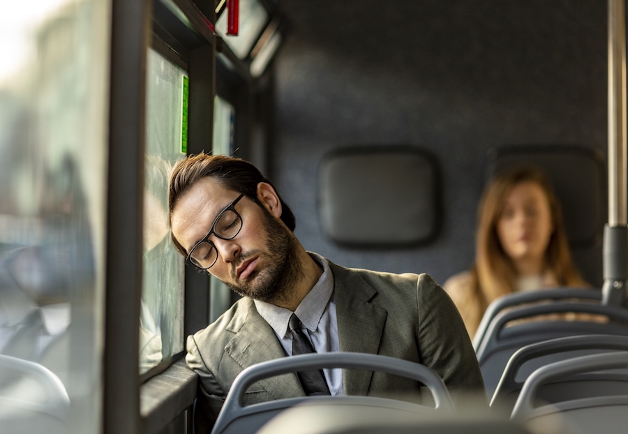 worker asleep on a bus