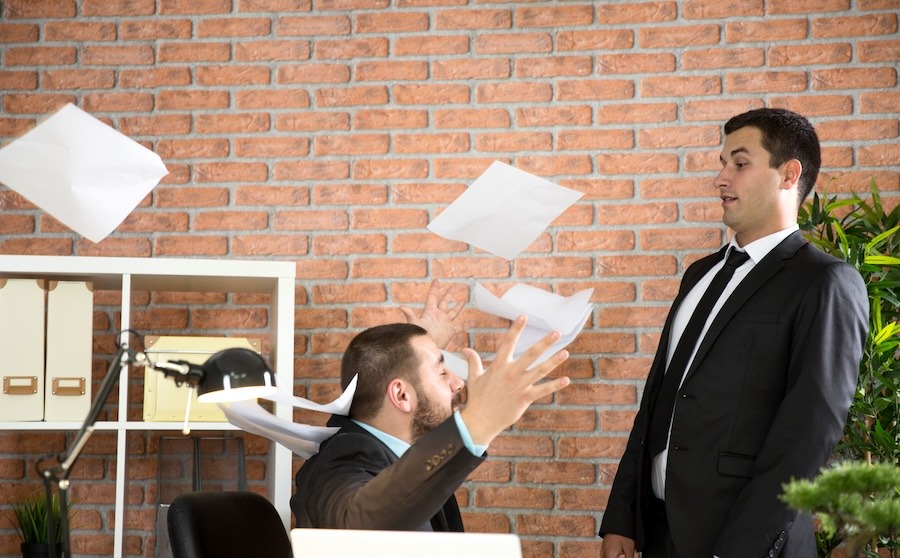 Worker throws papers at boss